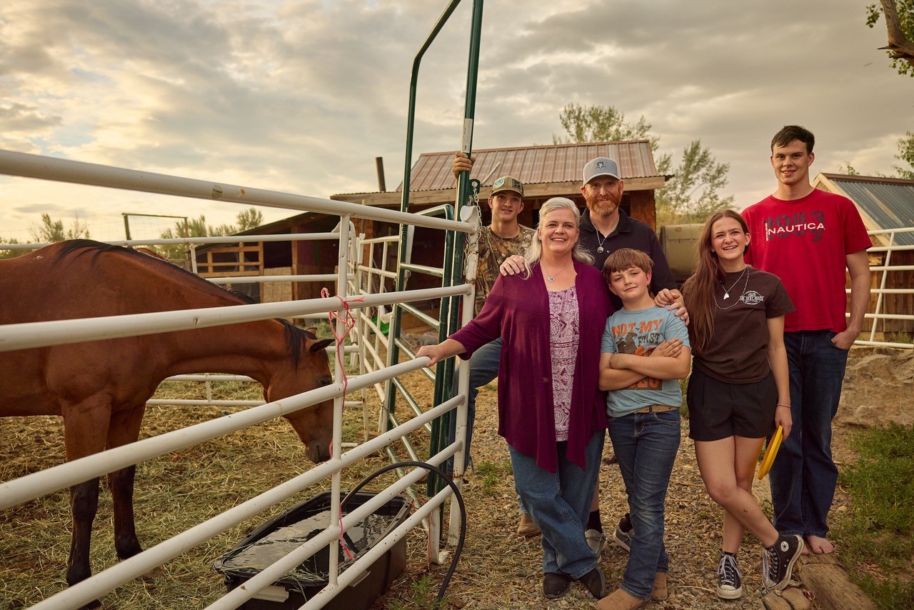 Jared Stock smiling with his family.