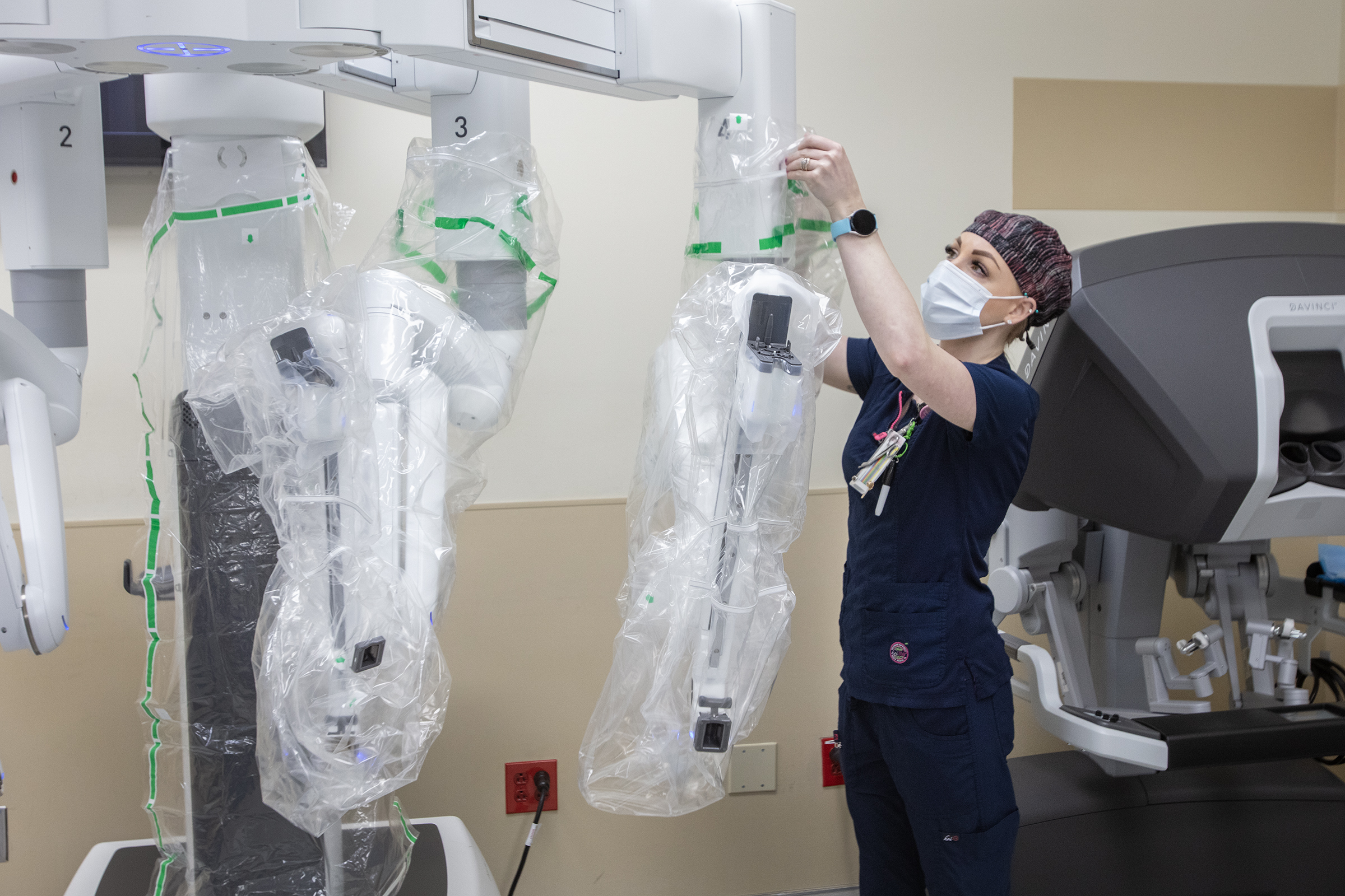Nurse draping the sterile covers on the da Vinci Xi robotic arms