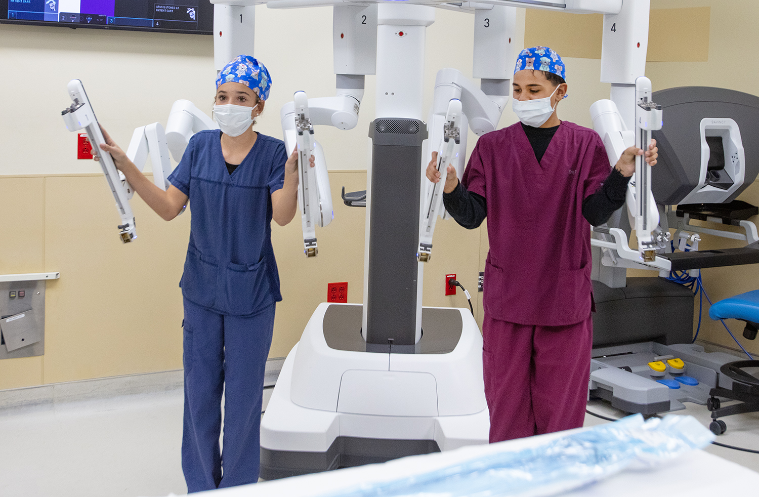 Two San Juan Regional team members positioning the da Vinci Xi robotic arms