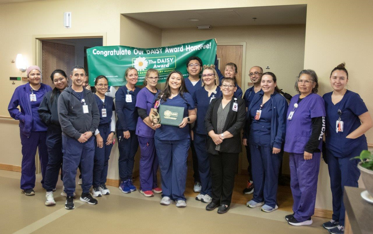 Jaecee Acosta with her team after receiving the DAISY Award.